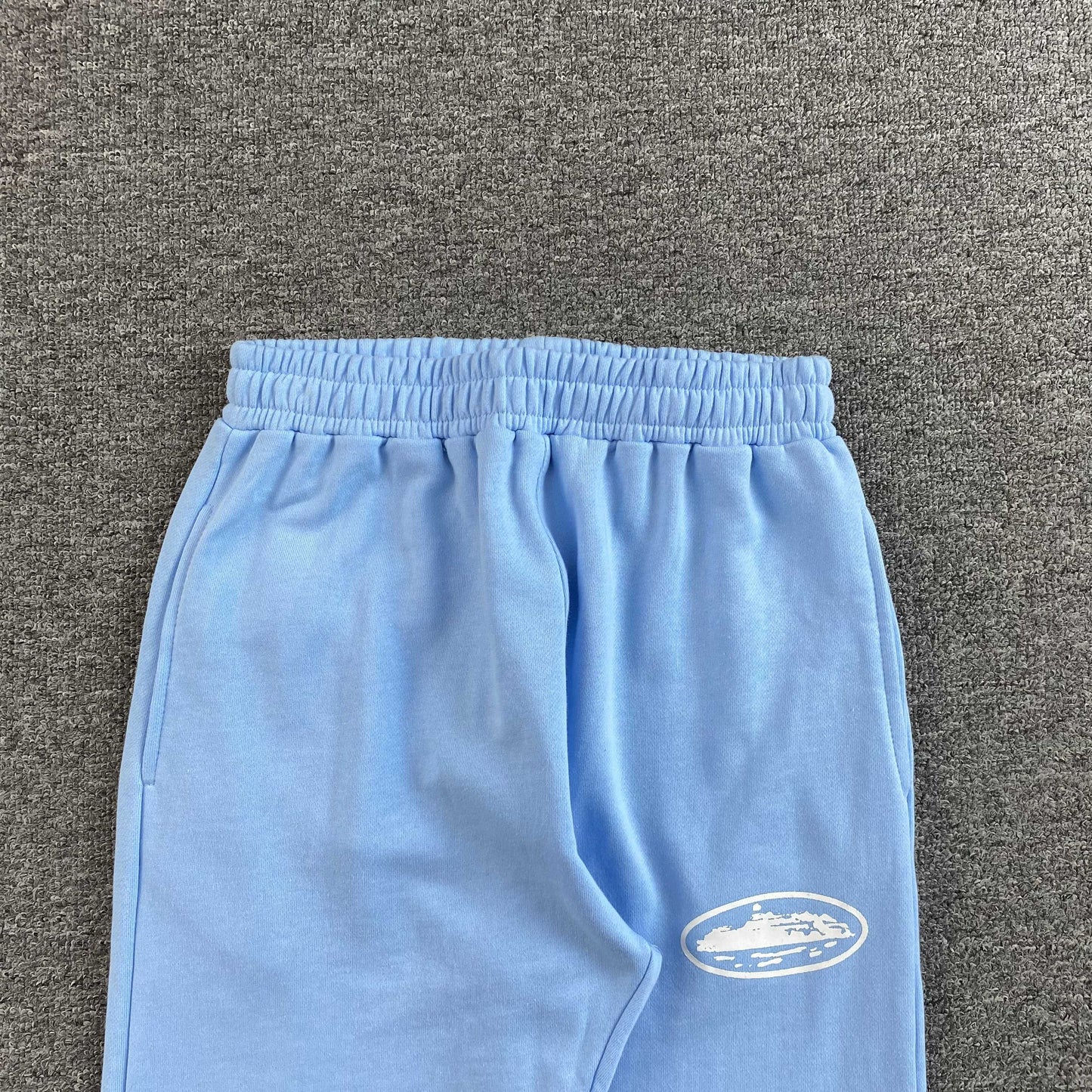 Corteiz Island Puff Print Open Hem Pants Baby Blue