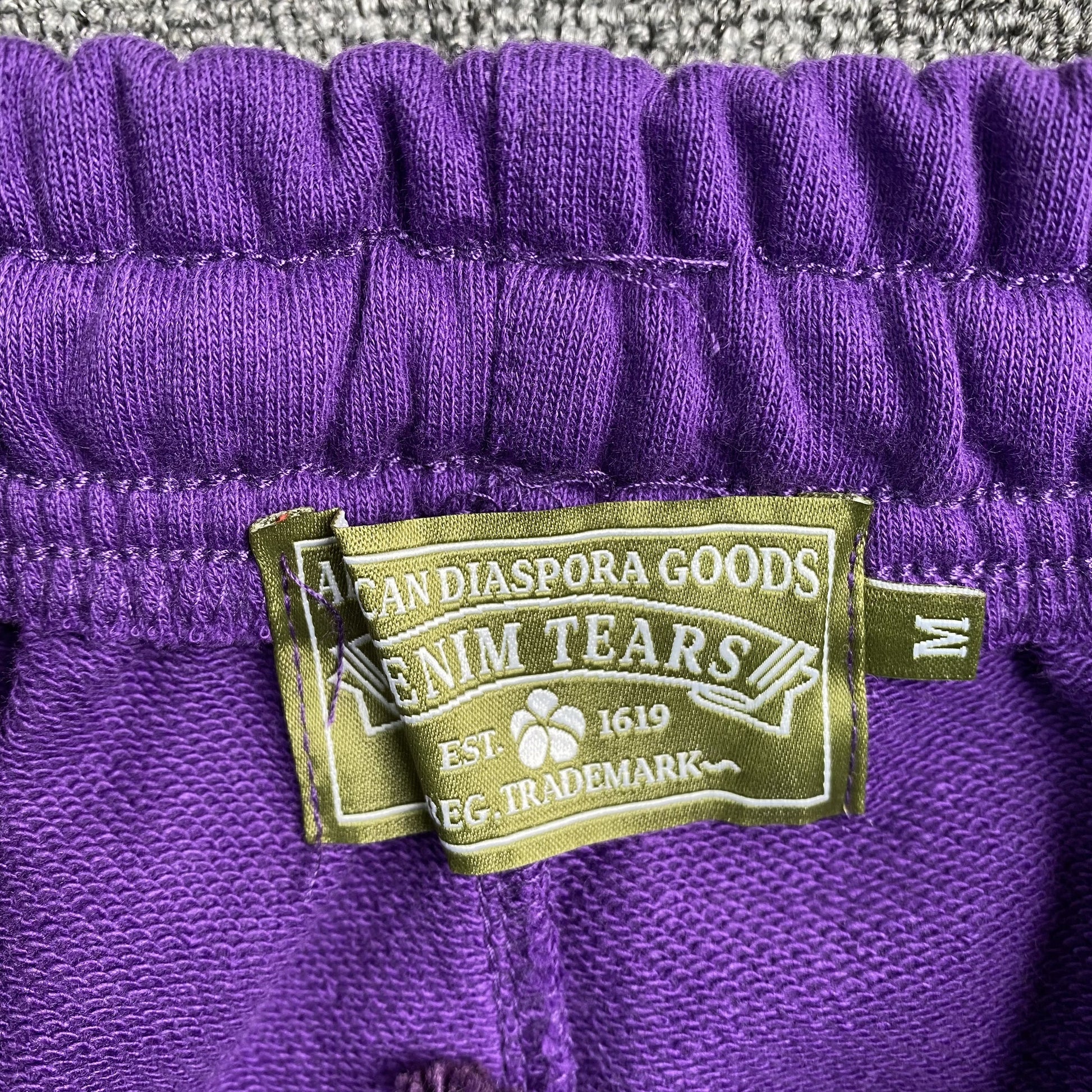 denim-tears-the-cotton-wreath-sweatpants-purple-3-Drip Store Argentina